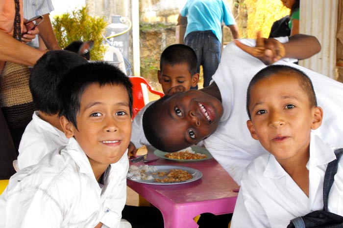 Young boys enjoying nutritious food from Breedlove Food aid packages.