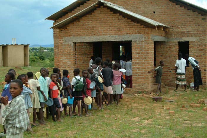 Children awaiting food from Breedlove Foods.