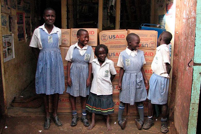 Children standing in front of Breedlove food shipment.