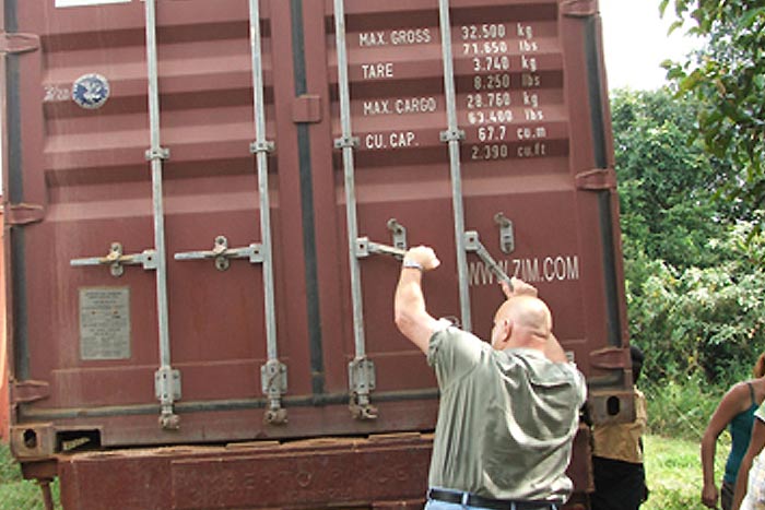 Aid relief staff opening rail car of Breedlove Foods shipment.