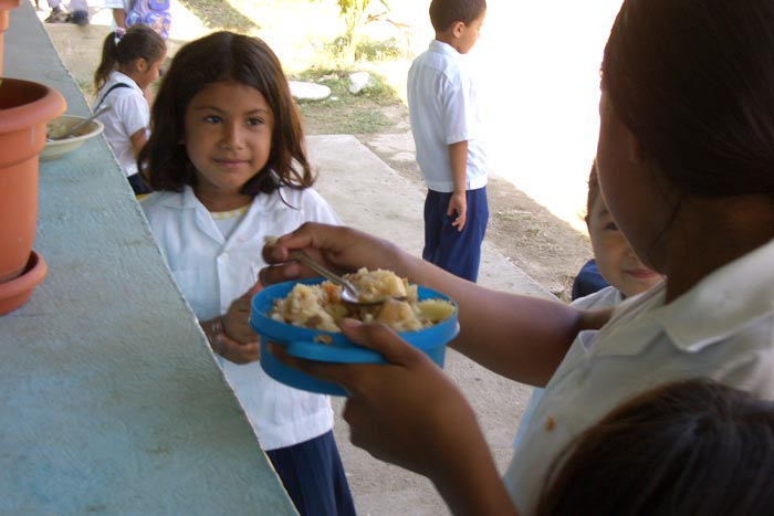 Children happy to receive a warm, nutritious meal.