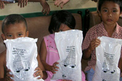 Young children happy to receive Breedlove food.